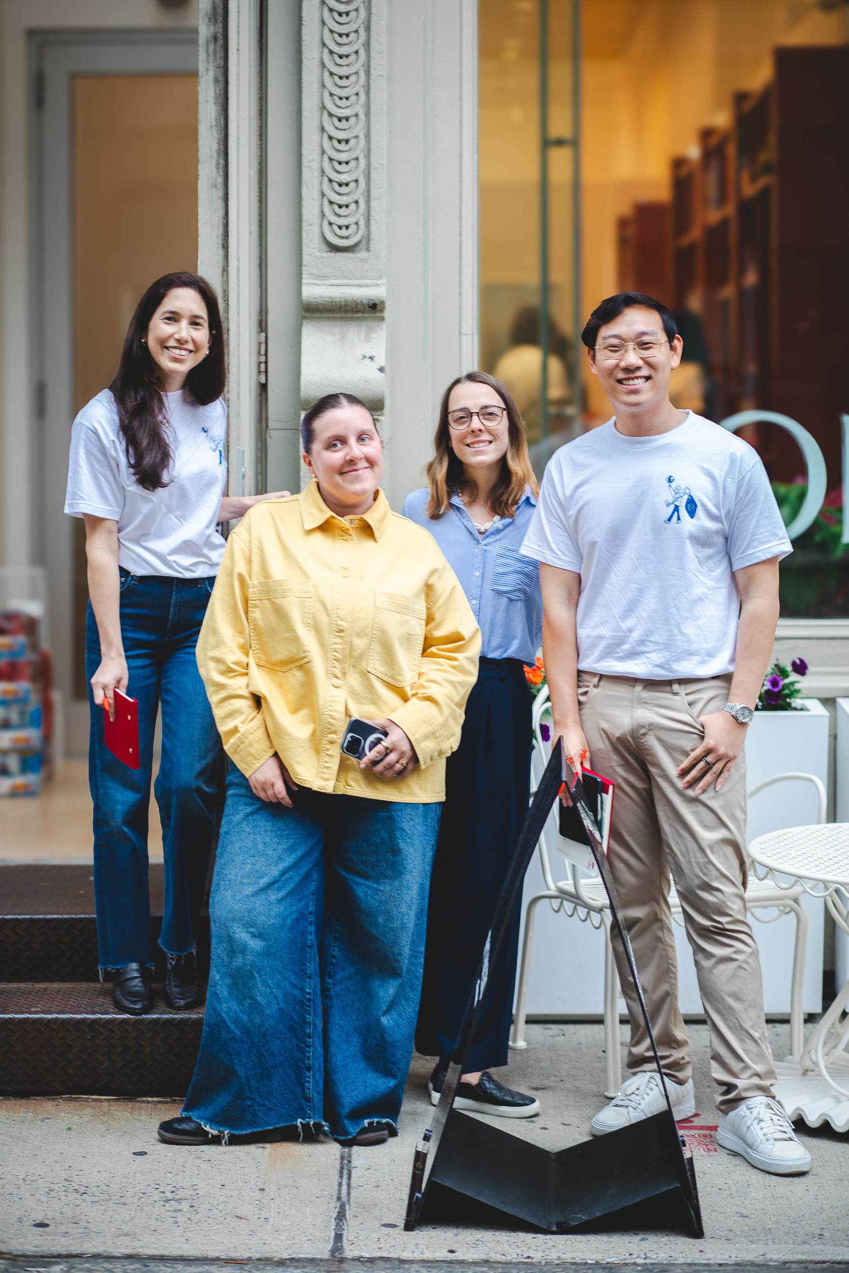 Fora team portrait, storefront steps