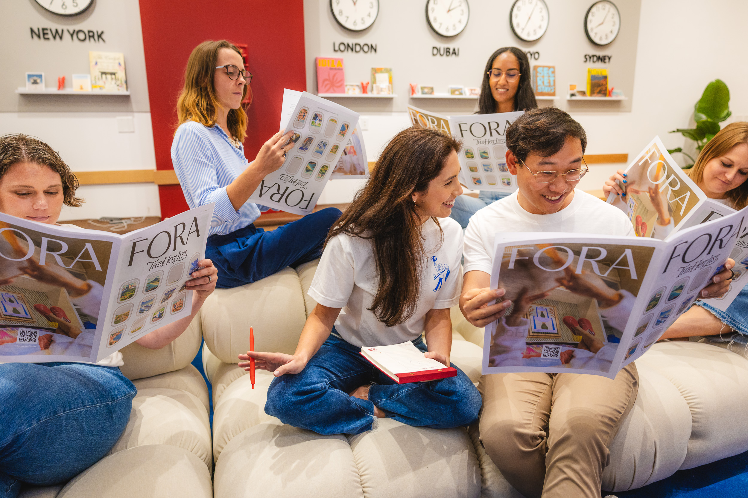 Fora team reading Hot List magazines
