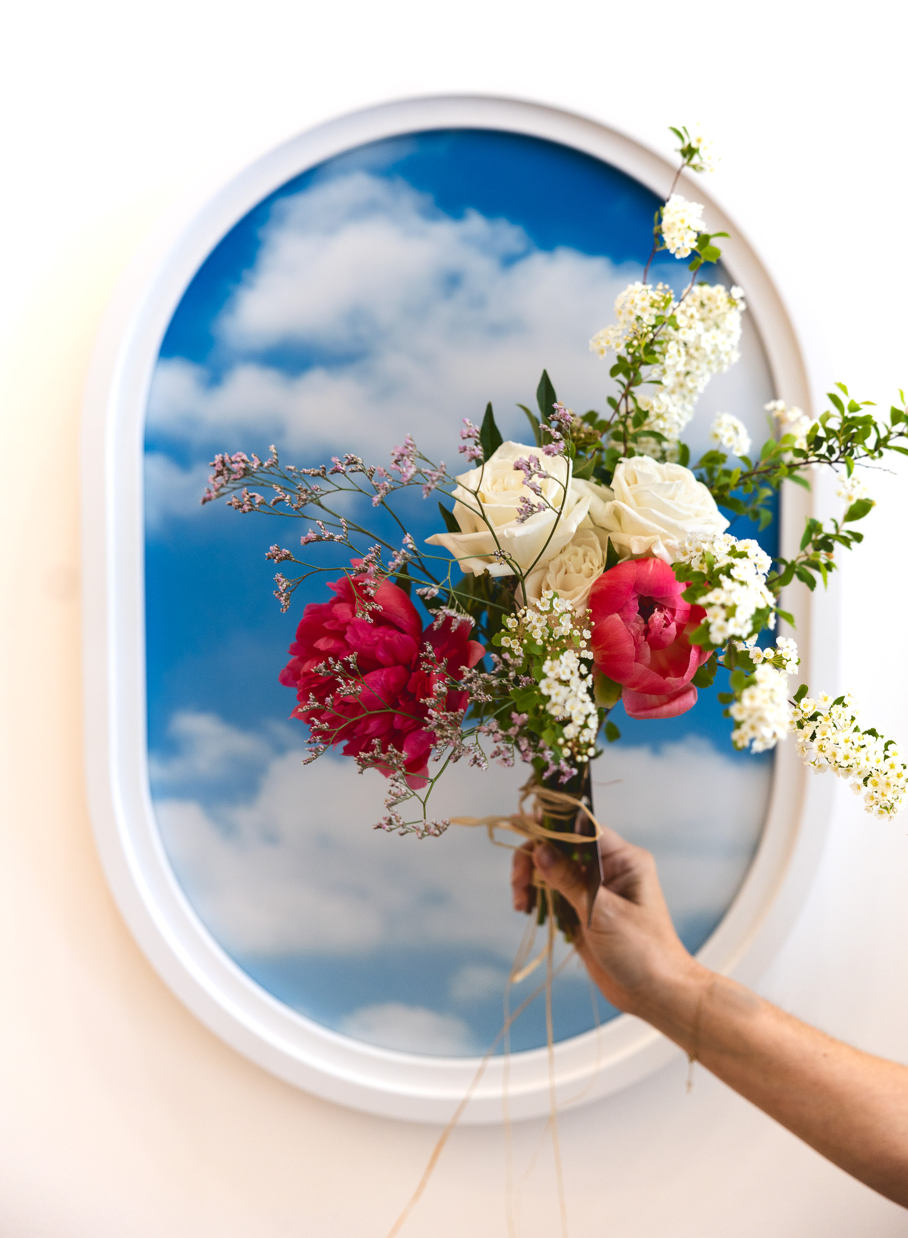 Bouquet held against Fora plane window installation