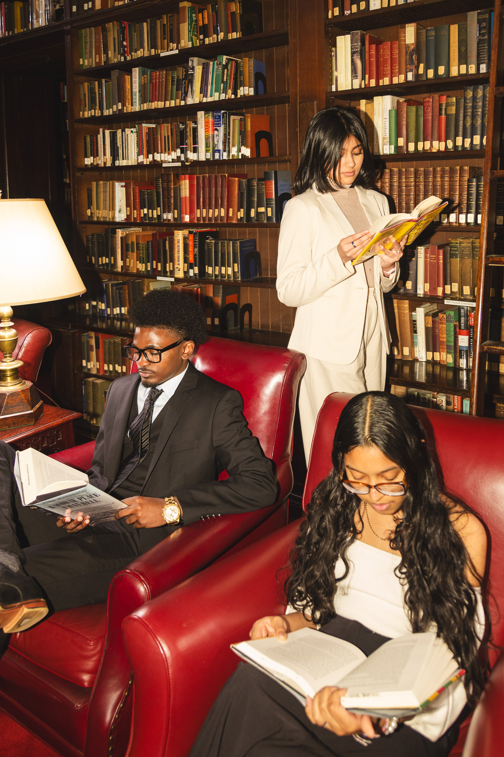 Young scholars reading, red leather chairs