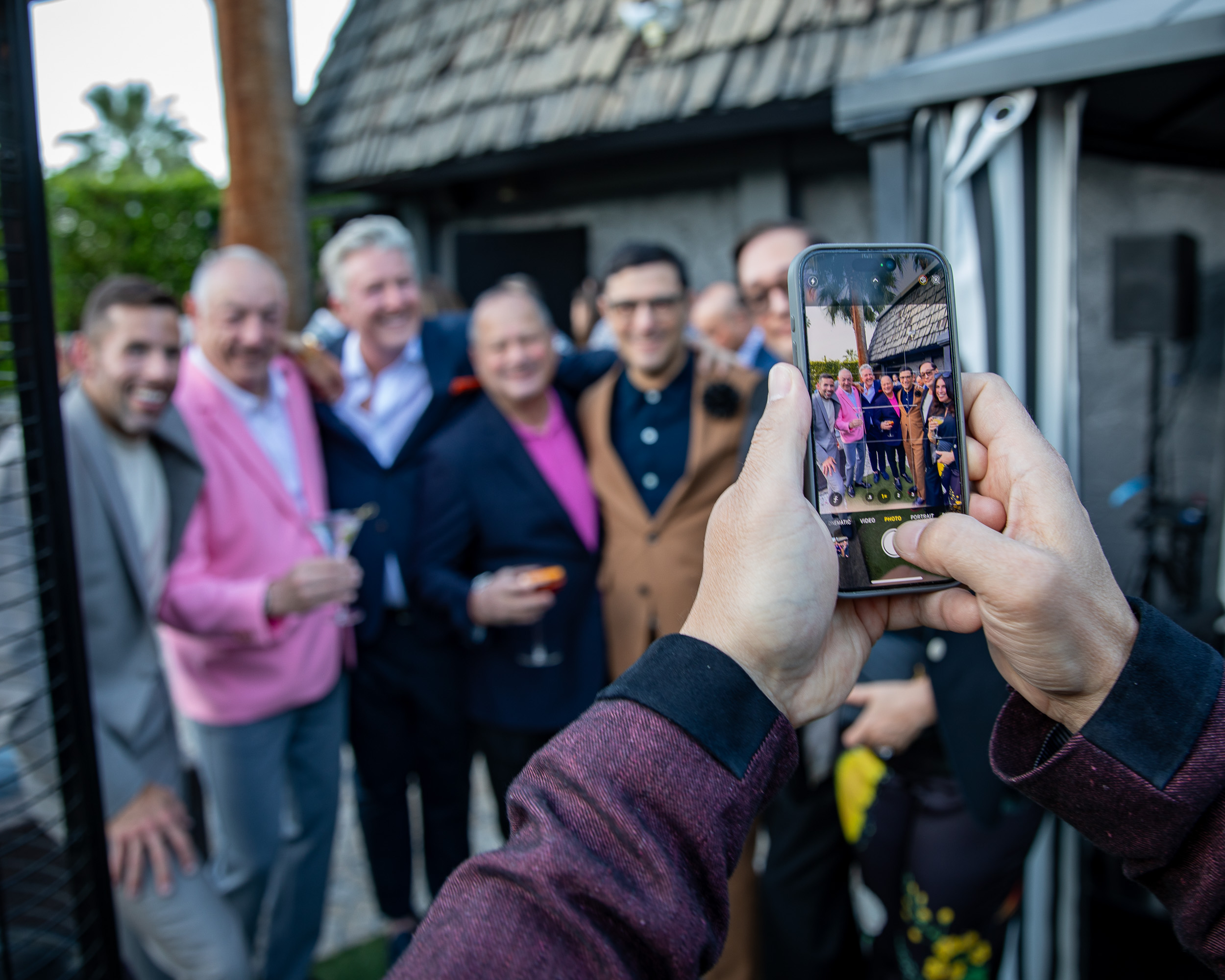 Group moment, someone photographing the group on a phone