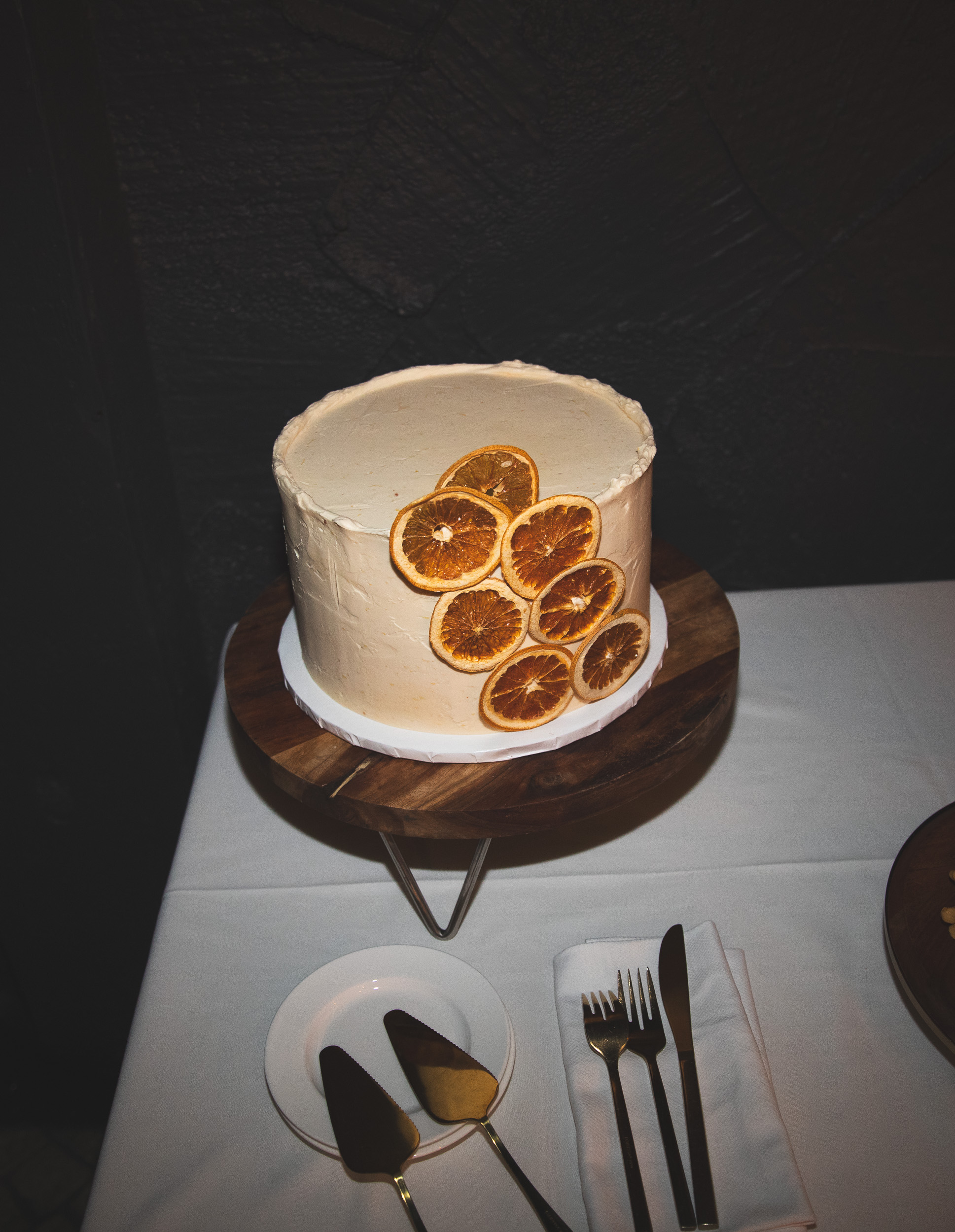 Wedding cake detail, dried orange slices on white frosting